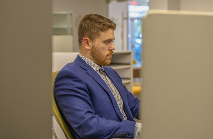 A Delta Media Group team member focused on work at a computer.