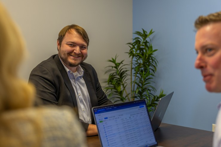 Two Delta Media Group team members smiling during a meeting.
