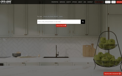 Crye-Leike Real Estate Services website homepage &mdash; a bright kitchen with a property search bar over For Sale, What's My Home Worth, and Solds tabs.