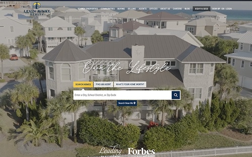 Levin Rinke Realty website homepage &mdash; an aerial view of a coastal home with 'Own the Lifestyle' over a property search bar.