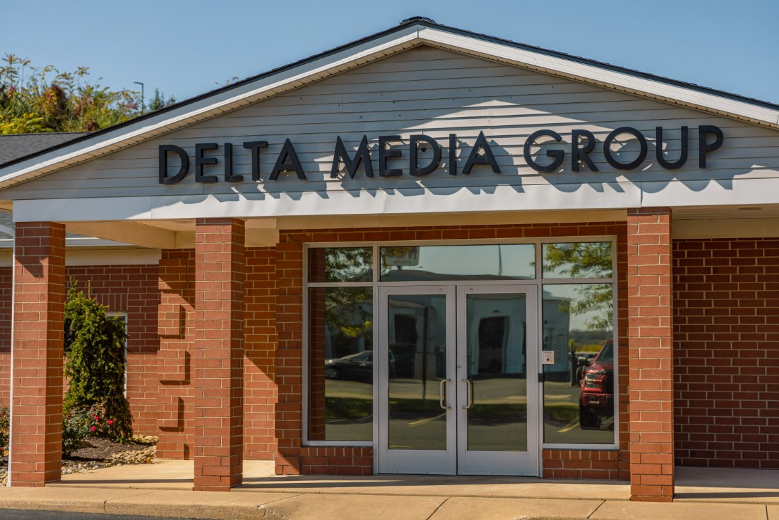The Delta Media Group office building exterior in North Canton, Ohio, with the company name above the entrance.